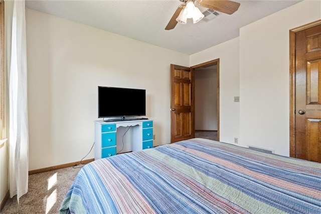 carpeted bedroom featuring baseboards and ceiling fan