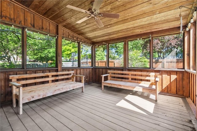 unfurnished sunroom with ceiling fan
