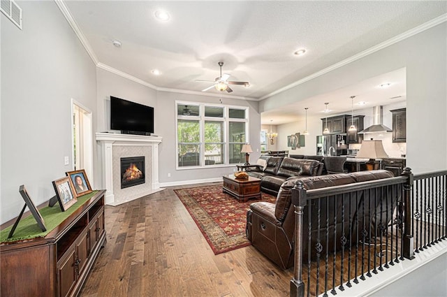 4310 N 141st Pl, Basehor, KS 66007 - living room with a ceiling fan, ornamental molding, dark wood-style flooring, recessed lighting, and a fireplace with flush hearth