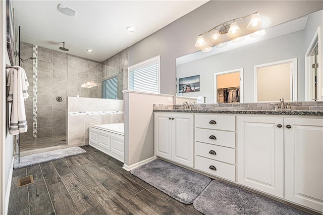 4310 N 141st Pl, Basehor, KS 66007 - full bath featuring wood finished floors, tiled shower, double vanity, and a bath
