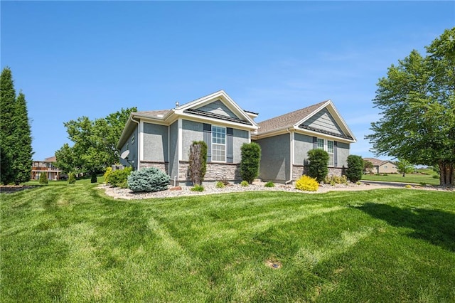 4310 N 141st Pl, Basehor, KS 66007 - view of front of home featuring a front lawn, stone siding, and stucco siding