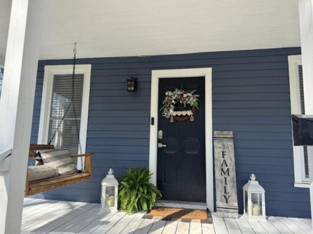 doorway to property featuring a porch