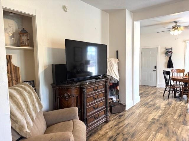 living area featuring ceiling fan and wood finished floors