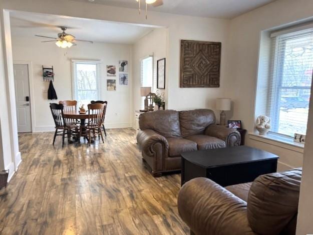 living room featuring a ceiling fan, wood finished floors, and baseboards