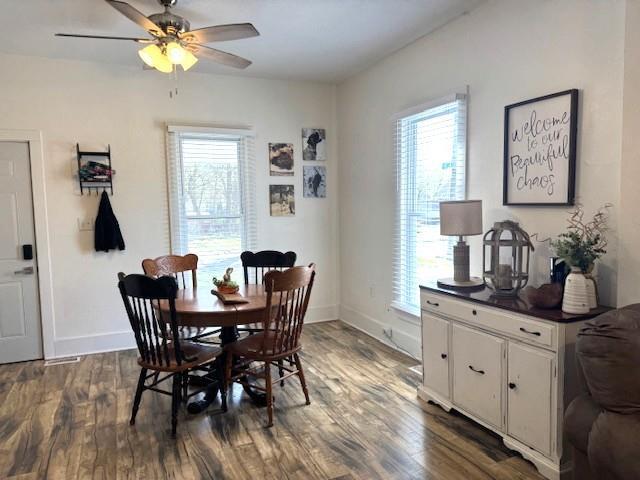 dining space featuring plenty of natural light, ceiling fan, and dark wood-style flooring