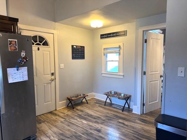 foyer entrance featuring wood finished floors and baseboards