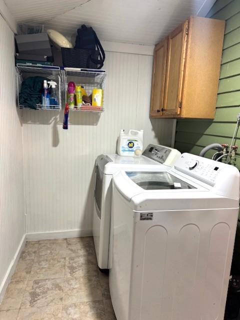 laundry room with separate washer and dryer, baseboards, and cabinet space