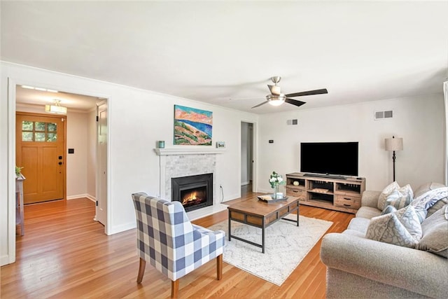 7408 Ash St, Prairie Village, KS 66208 - living room featuring light wood-style floors, a fireplace with flush hearth, baseboards, and a ceiling fan