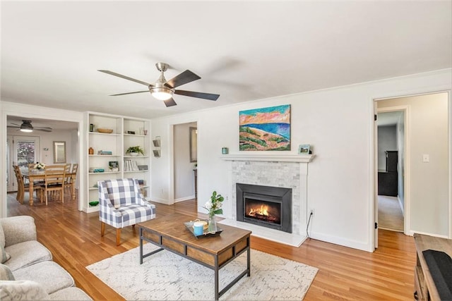 7408 Ash St, Prairie Village, KS 66208 - living area with ceiling fan, light wood-style floors, a tile fireplace, and baseboards
