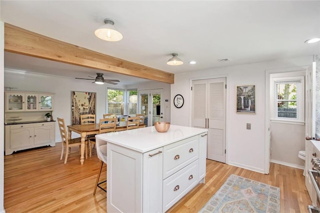 7408 Ash St, Prairie Village, KS 66208 - kitchen with plenty of natural light, white cabinetry, light wood-style flooring, recessed lighting, and beamed ceiling