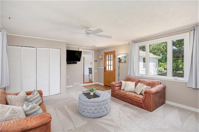 7408 Ash St, Prairie Village, KS 66208 - living area with light colored carpet, a ceiling fan, baseboards, and ornamental molding