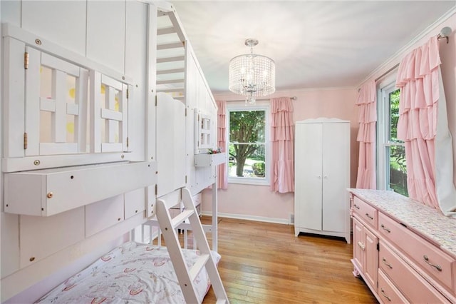 7408 Ash St, Prairie Village, KS 66208 - bedroom featuring a chandelier, light wood-style flooring, crown molding, and baseboards