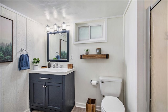 7408 Ash St, Prairie Village, KS 66208 - bathroom with vanity, toilet, baseboards, and wood finished floors