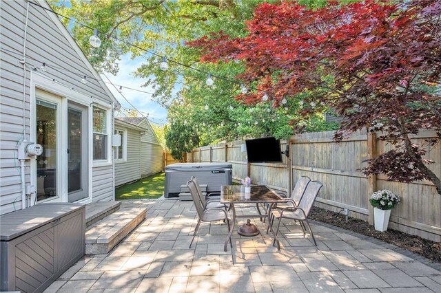 7408 Ash St, Prairie Village, KS 66208 - fenced backyard featuring a hot tub, a patio, and outdoor dining area