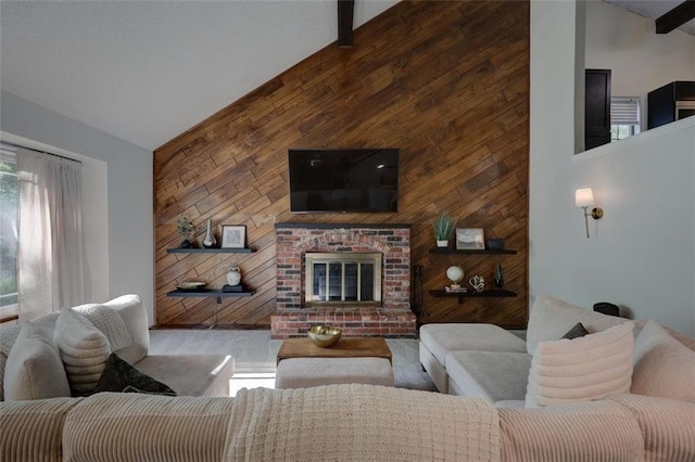 living area with wooden walls, an accent wall, a brick fireplace, and high vaulted ceiling
