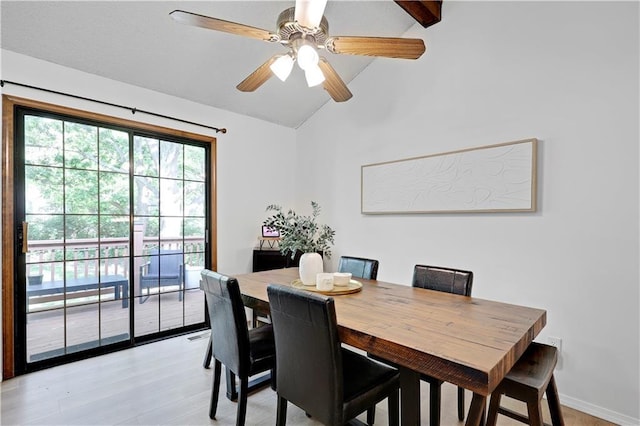 dining room with lofted ceiling, light wood finished floors, and a ceiling fan