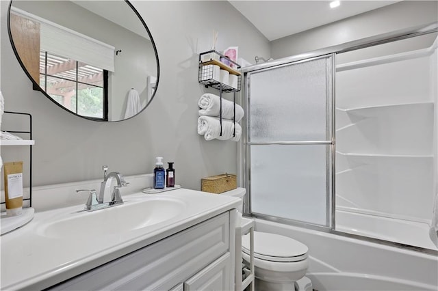 bathroom with toilet, vanity, and bath / shower combo with glass door