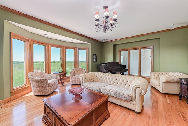 living room with a chandelier, ornamental molding, and light wood-style floors