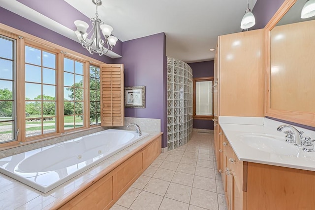 bathroom with tile patterned floors, a chandelier, a whirlpool tub, and vanity