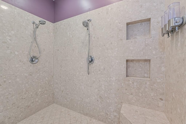 bathroom with a tile shower