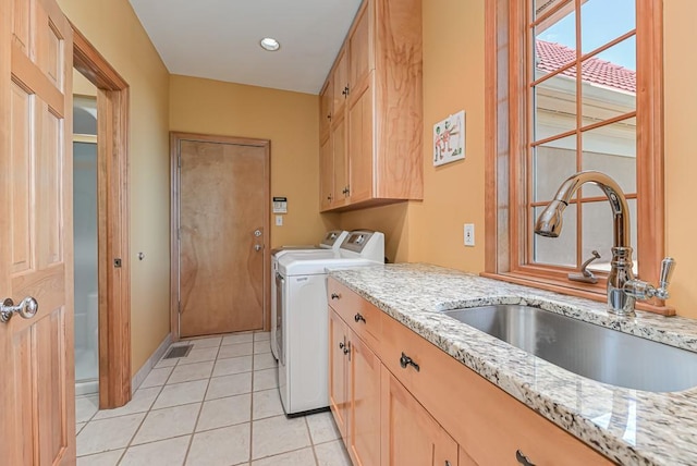 washroom featuring washer and clothes dryer, cabinet space, light tile patterned floors, and recessed lighting