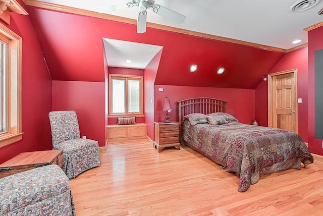 bedroom featuring wood finished floors, lofted ceiling, baseboards, ceiling fan, and ornamental molding