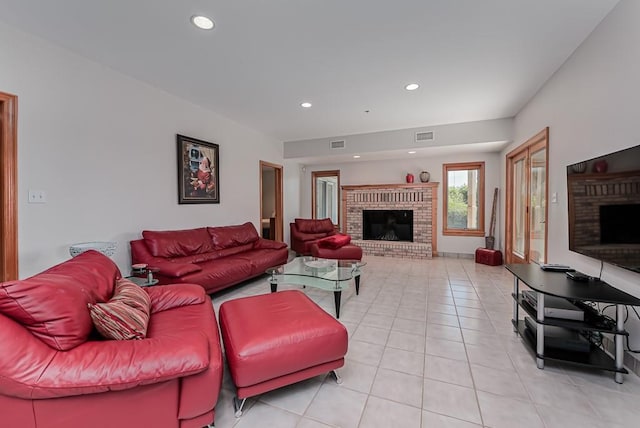 living area with a fireplace, light tile patterned floors, and recessed lighting