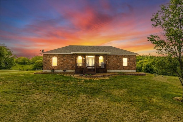 23780 Moberly Rd, Polo, MO 64671 - back of property at dusk featuring brick siding, a yard, and roof with shingles
