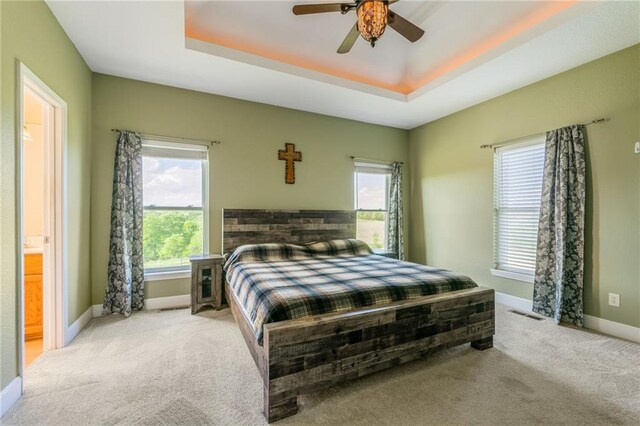 23780 Moberly Rd, Polo, MO 64671 - carpeted bedroom featuring multiple windows, baseboards, a raised ceiling, and a ceiling fan