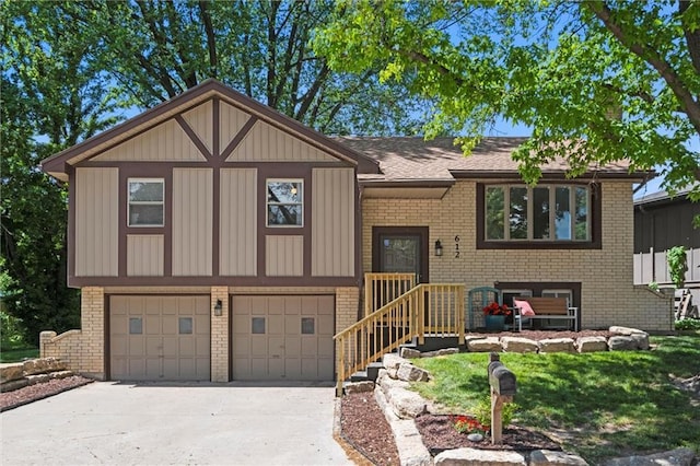 612 S 6th St, Edwardsville, KS 66111 - raised ranch with brick siding, driveway, and a garage