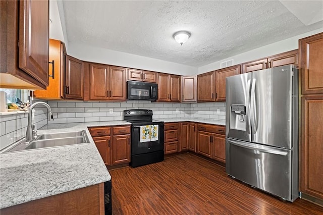 612 S 6th St, Edwardsville, KS 66111 - kitchen with black appliances, a sink, light countertops, dark wood-style floors, and a textured ceiling