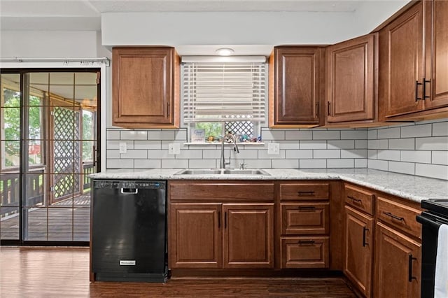 612 S 6th St, Edwardsville, KS 66111 - kitchen featuring black appliances, a sink, dark wood-style flooring, and decorative backsplash