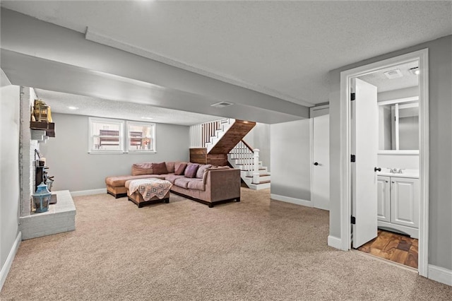 612 S 6th St, Edwardsville, KS 66111 - living area with carpet floors, stairs, baseboards, and a textured ceiling