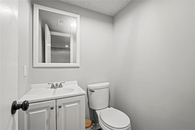 612 S 6th St, Edwardsville, KS 66111 - half bathroom with a textured ceiling, vanity, and toilet