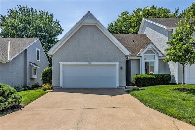 11065 W 98th St, Overland Park, KS 66214 - view of front facade with a garage, stucco siding, concrete driveway, and a front lawn
