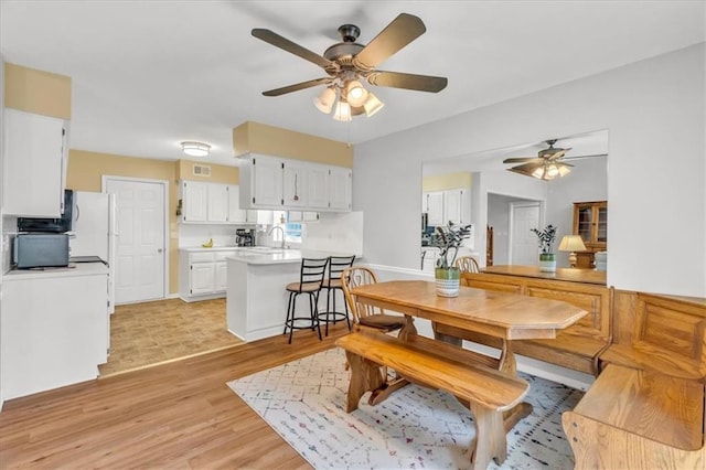 11065 W 98th St, Overland Park, KS 66214 - dining area with a ceiling fan and light wood-style flooring