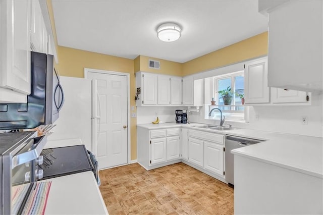 11065 W 98th St, Overland Park, KS 66214 - kitchen featuring appliances with stainless steel finishes, white cabinetry, and light countertops