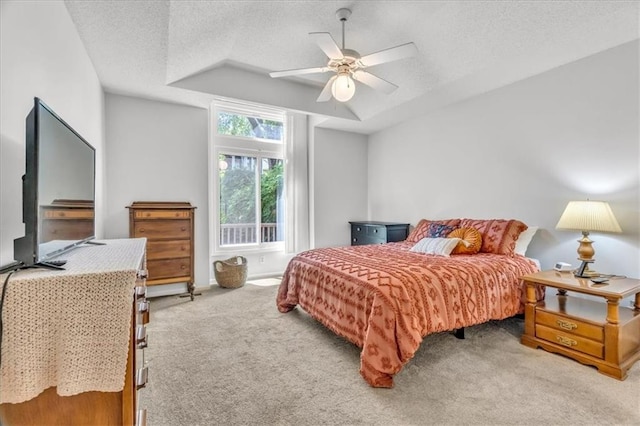 11065 W 98th St, Overland Park, KS 66214 - bedroom featuring light colored carpet, a textured ceiling, a raised ceiling, and a ceiling fan