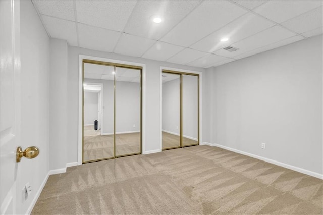 11065 W 98th St, Overland Park, KS 66214 - unfurnished bedroom with multiple closets, carpet, and a drop ceiling
