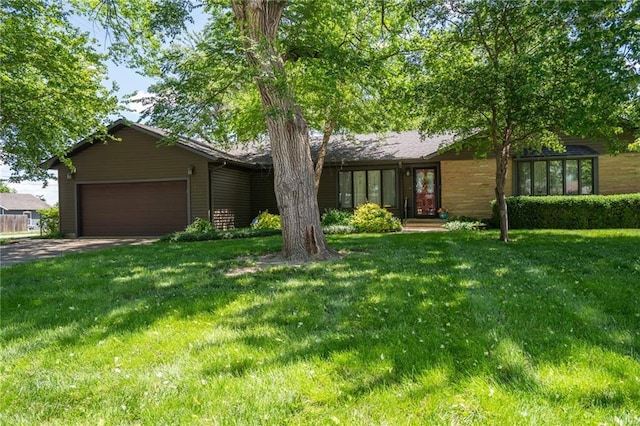 view of front facade with an attached garage, driveway, and a front lawn