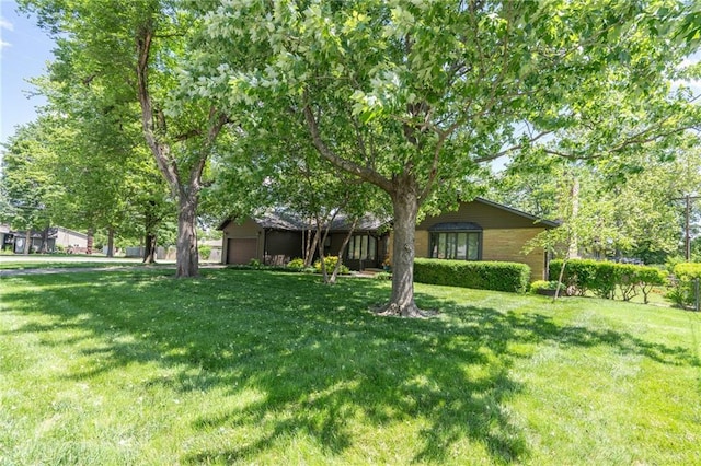 view of grassy yard featuring an attached garage