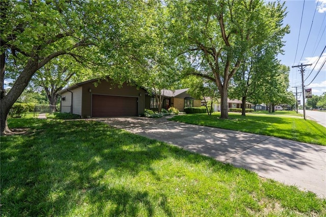 view of front of property featuring a front lawn, a garage, and concrete driveway