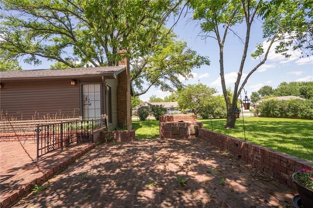 view of grassy yard featuring a patio area