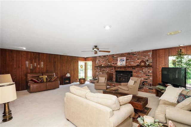 living room featuring wooden walls, light colored carpet, and ceiling fan