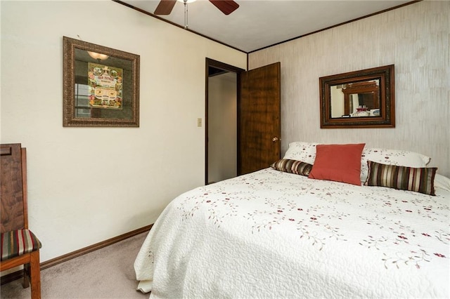 carpeted bedroom featuring baseboards, crown molding, and ceiling fan