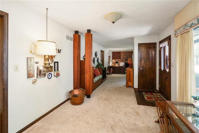 hallway with carpet flooring and baseboards