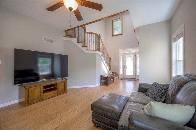 1906 Blackbird Cir, Kearney, MO 64060 - living area with stairway, a ceiling fan, light wood finished floors, and high vaulted ceiling
