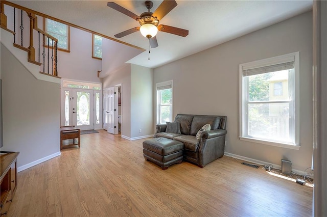 1906 Blackbird Cir, Kearney, MO 64060 - living room featuring ceiling fan, light wood-style floors, and stairway