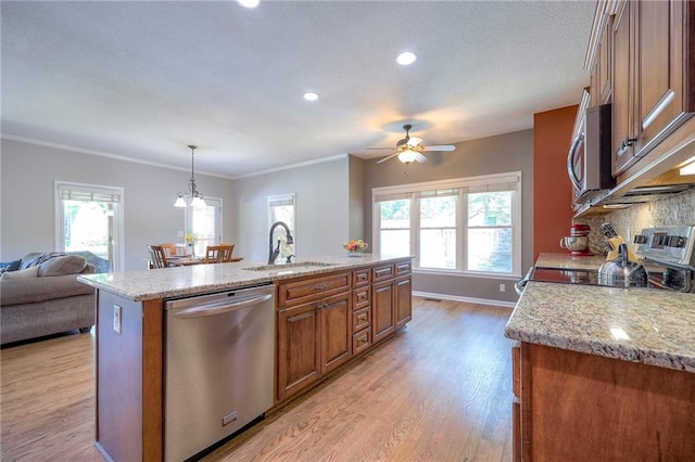 1906 Blackbird Cir, Kearney, MO 64060 - kitchen with stainless steel appliances, brown cabinetry, a ceiling fan, light stone counters, and ornamental molding