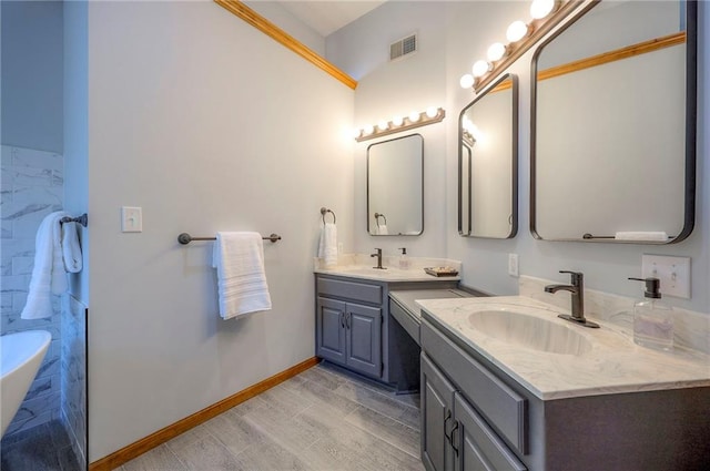 1906 Blackbird Cir, Kearney, MO 64060 - bathroom featuring two vanities and a freestanding tub